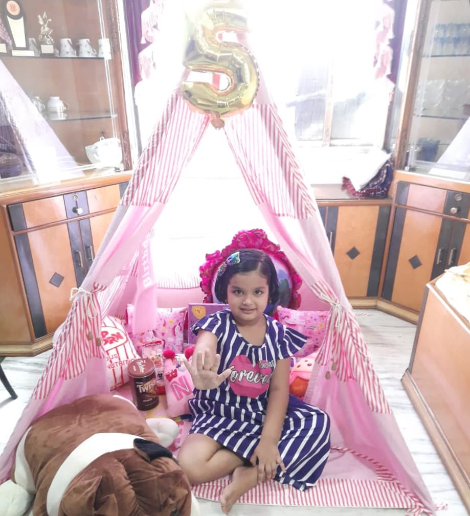 girl celebrating her birthday in pink tent house