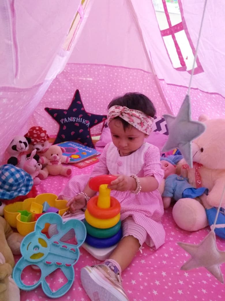 baby playing in a pink A-Shape tent