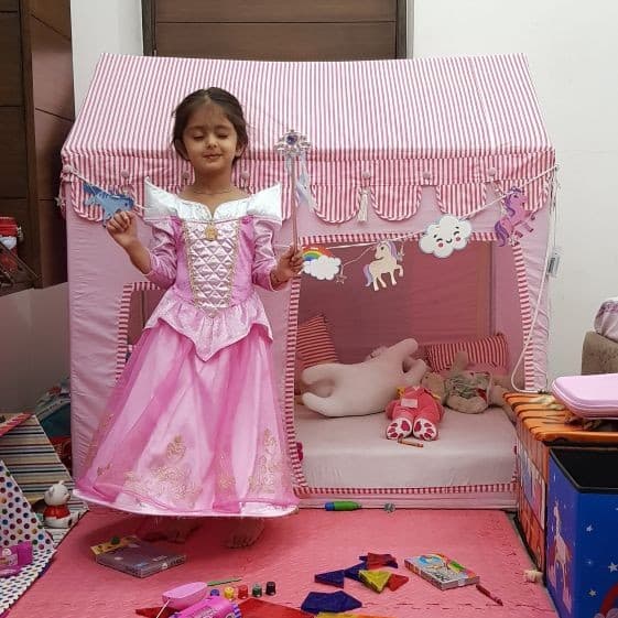 girl posing with her pink tent house