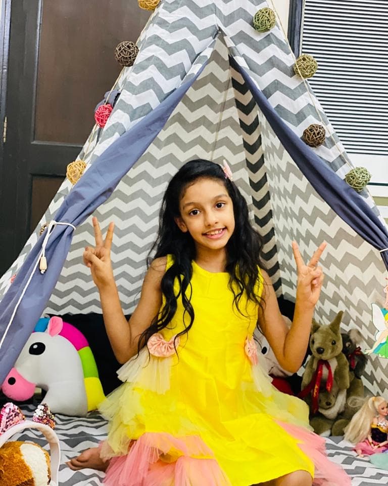 girl camping in her kids play tent