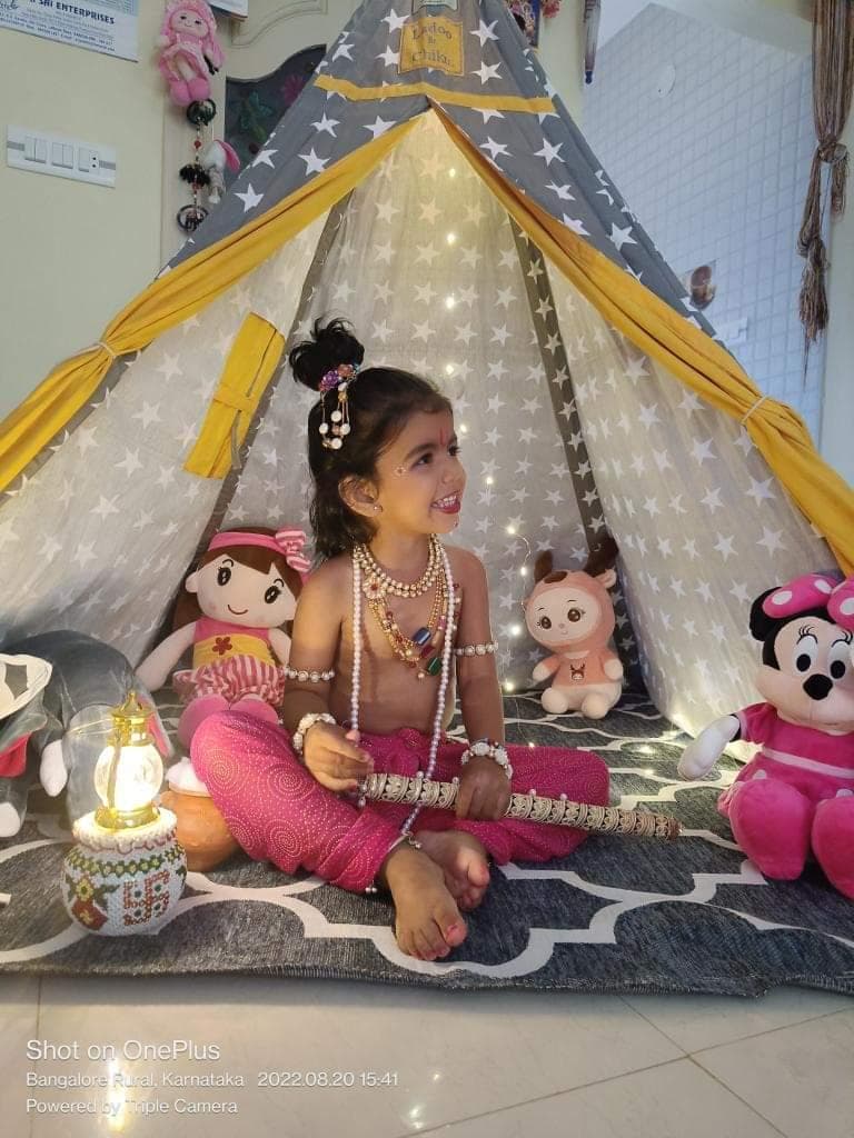 little krishna posing in his play tent