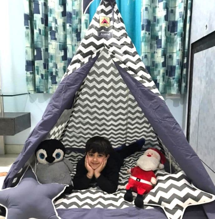 tent house for kids in grey color set up in a kids room