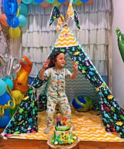 boy dancing with joy to see his dinosaur teepee tent house